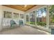 Bright sunroom featuring wood ceiling, multiple windows, and peaceful backyard views at 618 Buttonwood Dr, Longboat Key, FL 34228