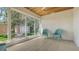 Inviting sunroom with multiple windows, hardwood floors, and scenic outdoor views at 618 Buttonwood Dr, Longboat Key, FL 34228