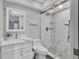 Bathroom featuring new vanity with white countertop and updated shower with a white marble-style surround at 6423 Egret Ln # 402, Bradenton, FL 34210
