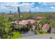 Exterior view of a two-story condominium building with mature trees and a glimpse of the ocean at 6423 Egret Ln # 402, Bradenton, FL 34210