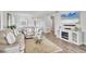Bright living room with comfortable sofas, fireplace, and view of the kitchen at 6423 Egret Ln # 402, Bradenton, FL 34210