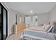 Bright main bedroom featuring light gray walls, ceiling fan, and sliding glass doors for lots of natural light at 6423 Egret Ln # 402, Bradenton, FL 34210
