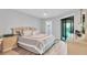 Serene main bedroom with an ensuite bathroom, closet and sliding glass doors to a balcony at 6423 Egret Ln # 402, Bradenton, FL 34210