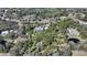 Wide aerial view of a private property nestled among trees, with a stunning home, in-ground pool, and winding driveway at 7157 Saddle Creek Cir, Sarasota, FL 34241