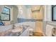 Stylish bathroom with a modern sink, textured white walls, and a glass-enclosed shower with blue accents at 7157 Saddle Creek Cir, Sarasota, FL 34241