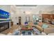 Cozy living room features a fireplace, hardwood flooring, and a plush sectional sofa at 7157 Saddle Creek Cir, Sarasota, FL 34241