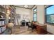 Well-appointed home office with custom bookshelves, a rolling ladder, and two separate desks for work and study at 7157 Saddle Creek Cir, Sarasota, FL 34241