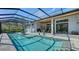 An in-ground screened pool, situated next to a covered outdoor living space at 7157 Saddle Creek Cir, Sarasota, FL 34241