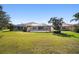 Large backyard view highlighting the screened in patio and tile roof at 7623 Camminare Dr, Sarasota, FL 34238