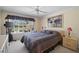 Relaxing bedroom with a large window overlooking a nice backyard and neutral-toned walls at 7623 Camminare Dr, Sarasota, FL 34238