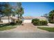 Charming villa featuring a tile roof, brick paver driveway, and a two-car garage at 7623 Camminare Dr, Sarasota, FL 34238
