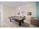 Inviting game room features a stylish pool table, neutral carpet, and comfortable seating at 7623 Camminare Dr, Sarasota, FL 34238