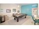 Bright game room with a pool table, bar stools, and a partial view into an ensuite bathroom at 7623 Camminare Dr, Sarasota, FL 34238