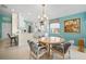 Eat-in kitchen features tile flooring, white cabinetry, and an abundance of natural light at 7623 Camminare Dr, Sarasota, FL 34238
