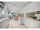 Clean white kitchen with generous countertops and a convenient breakfast bar area at 7623 Camminare Dr, Sarasota, FL 34238
