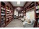 Cozy library with floor-to-ceiling bookshelves, comfortable seating, and maps, perfect for reading and relaxation at 7623 Camminare Dr, Sarasota, FL 34238