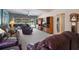Spacious living area with neutral carpet, a built-in bookcase, and access to the lanai at 7623 Camminare Dr, Sarasota, FL 34238