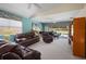 Comfortable living room with plush leather seating, neutral carpet, and a grand piano at 7623 Camminare Dr, Sarasota, FL 34238