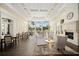 Elegant living room with large windows, fireplace, and comfortable seating offers a refined community gathering space at 7623 Camminare Dr, Sarasota, FL 34238