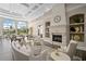 Bright living room with a fireplace, soaring ceilings, and elegant furnishings, creating a welcoming and luxurious space at 7623 Camminare Dr, Sarasota, FL 34238