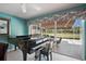 Bright living area showcases a grand piano and seamless access to the outdoors at 7623 Camminare Dr, Sarasota, FL 34238