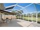 Spacious screened patio with seating area and retractable awning provides shade and comfort at 7623 Camminare Dr, Sarasota, FL 34238