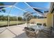 Spacious screened patio with comfortable seating and a retractable awning offers relaxation at 7623 Camminare Dr, Sarasota, FL 34238