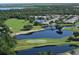 Aerial view of the golf course, lakes, and community at 8536 54Th Avenue E Cir, Bradenton, FL 34211