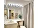 Well-lit bathroom with shower and tub, featuring a large vanity mirror and plant at 8536 54Th Avenue E Cir, Bradenton, FL 34211
