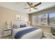 Cozy bedroom featuring a ceiling fan, neutral color scheme, and a serene view from the window at 8536 54Th Avenue E Cir, Bradenton, FL 34211