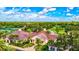 An aerial view of the clubhouse showcases a beautiful entrance and lush surroundings at 8536 54Th Avenue E Cir, Bradenton, FL 34211