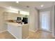 Bright dining area open to kitchen with views of backyard, featuring modern light fixture and wood-look flooring at 8536 54Th Avenue E Cir, Bradenton, FL 34211