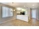 Bright dining area featuring a modern chandelier and breakfast bar adjacent to the kitchen at 8536 54Th Avenue E Cir, Bradenton, FL 34211