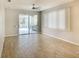Spacious room with wood-look tile flooring and sliding glass doors leading to an outdoor area at 8536 54Th Avenue E Cir, Bradenton, FL 34211