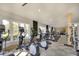 Well-equipped gym space with treadmills, elliptical machines, and bright natural light at 8536 54Th Avenue E Cir, Bradenton, FL 34211