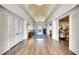 Elegant hallway with wood flooring, white trim, and access to dining and lounge areas at 8536 54Th Avenue E Cir, Bradenton, FL 34211