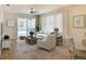 Comfortable living room with ceiling fan, adjacent dining area, and sliding door to screened patio at 8536 54Th Avenue E Cir, Bradenton, FL 34211