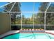 Screened-in pool area features an in-ground pool overlooking the tranquil lake at 8536 54Th Avenue E Cir, Bradenton, FL 34211