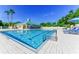 Community pool with sun loungers and a clubhouse surrounded by lush greenery at 8536 54Th Avenue E Cir, Bradenton, FL 34211