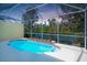 Refreshing screened-in pool overlooking a tranquil lake and lush greenery at 8536 54Th Avenue E Cir, Bradenton, FL 34211