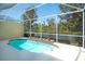 Refreshing screened-in pool overlooking a tranquil lake and lush greenery at 8536 54Th Avenue E Cir, Bradenton, FL 34211