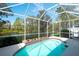 Refreshing screened-in pool overlooking a tranquil lake and lush greenery at 8536 54Th Avenue E Cir, Bradenton, FL 34211