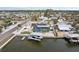 Waterfront home featuring a private dock, screened-in pool, solar panels, and lush tropical landscaping at 928 Spindle Palm Way, Apollo Beach, FL 33572