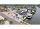 Waterfront home featuring a private dock, screened-in pool, solar panels, and lush tropical landscaping at 928 Spindle Palm Way, Apollo Beach, FL 33572