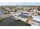 Waterfront home featuring a private dock, screened-in pool, lush tropical landscaping and canal access at 928 Spindle Palm Way, Apollo Beach, FL 33572