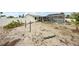 Large backyard needing lawn care, with screened pool area, and partial white fence in a sunny setting at 928 Spindle Palm Way, Apollo Beach, FL 33572