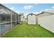 Backyard featuring lush artificial turf, offering a low-maintenance and visually appealing outdoor space at 928 Spindle Palm Way, Apollo Beach, FL 33572