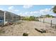 View of a large backyard needing some TLC; the possibilities are endless with this blank canvas at 928 Spindle Palm Way, Apollo Beach, FL 33572