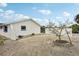 Fenced backyard with a white fence and small tree at 928 Spindle Palm Way, Apollo Beach, FL 33572