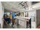 Basement featuring fishing poles on the ceiling, cabinets, washer and dryer, and door for convenience at 928 Spindle Palm Way, Apollo Beach, FL 33572